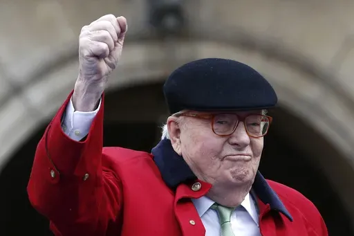 Former far-right National Front party leader Jean-Marie Le Pen clenches his fist at the statue of Joan of Arc, Monday May 1, 2017, in Paris. (AP Photo/Kamil Zihnioglu, File)