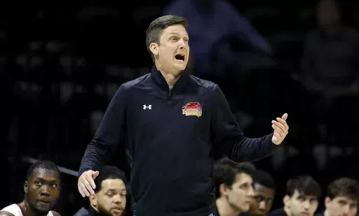 Loyola-New Orleans coach Stacy Hollowell reacts during the first half of the team's NAIA men's championship college basketball game against Talladega on March 22, 2022, in Kansas City, Mo. The University of New Orleans has hired Hollowell as basketball coach. Two years ago, Hollowell coached Loyola to an NAIA championship. Following that season, he joined the staff of then-Mississippi coach Kermit Davis, but left Ole Miss in 2023 after Davis was fired. (AP Photo/Colin E. Braley, File)