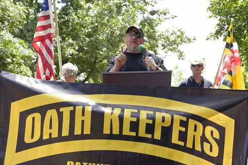 Stewart Rhodes, founder of the Oath Keepers, center, speaks during a rally outside the White House in Washington, June 25, 2017. Hundreds of pages of court documents in the case against Rhodes and four co-defendants, whose trial opens with jury selection Tuesday, Sept. 27, 2022, in Washington's federal court, paint a picture of a group so determined to overturn Biden's election that some members were prepared to lose their lives to do so. (AP Photo/Susan Walsh, File)