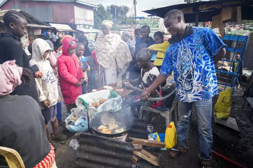 A man uses cooking oil to fry Mandazi, a type of fried bread, on a street in the low-income Kibera neighborhood of Nairobi, Kenya, Wednesday, April 20, 2022. Global cooking oil prices have been rising since the COVID-19 pandemic began and Russia's war in Ukraine has sent costs spiralling. It is the latest fallout to the global food supply from the war, with Ukraine and Russia the world’s top exporters of sunflower oil. And it's another rising cost pinching households and businesses as inflatio