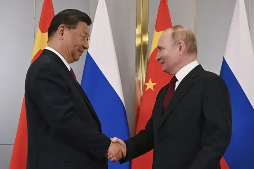 FILE -Russian President Vladimir Putin, right, and Chinese President Xi Jinping shake hands during their meeting on the sidelines of the Shanghai Cooperation Organisation (SCO) summit in Astana, Kazakhstan, July 3, 2024. China has accused NATO of seeking security at the expense of others and told the alliance not to bring the same “chaos” to Asia. The statement from a Foreign Ministry spokesperson on Thursday came a day after NATO labeled China a “decisive enabler” of Russia’s war agai
