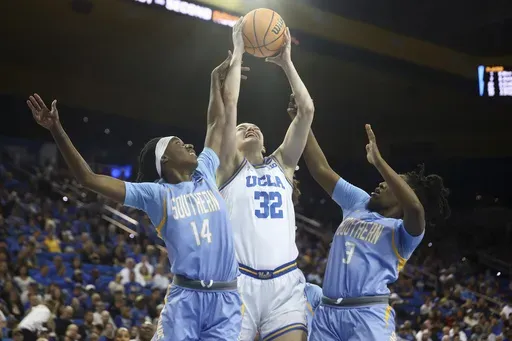 UCLA forward Angela Dugalic (32), Southern guard Soniyah Reed (14) and Southern guard Taniya Lawson (3) reach for a rebound during the first half in the first round of the NCAA college basketball tournament Friday, March 21, 2025, in Los Angeles. (AP Photo/Jessie Alcheh)