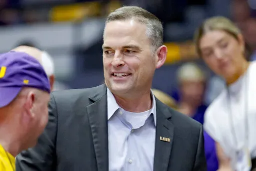 Former Murray State head coach Matt McMahon, center, talks with LSU fans after being hired as the head men's basketball coach for LSU during the second half of a women's college basketball game against Ohio State in the second round of the NCAA tournament, Monday, March 21, 2022, in Baton Rouge, La. Not long after Matt McMahon was hired to take over a Tigers program which remains under investigation because of NCAA allegations against former coach Will Wade, virtually every player on the roster 