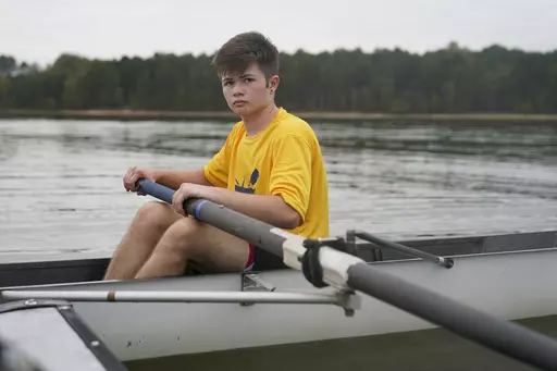 Callum Bradford rows during a club team practice at Jordan Lake, Friday, Oct. 6, 2023, in Apex, N.C. Bradford, a transgender teen from Chapel Hill needed mental health care after overdosing on prescription drugs. He was about to be transferred to another hospital due to a significant bed shortage. A North Carolina hospital network is referring transgender psychiatric patients to treatment facilities that do not align with their gender identities. Though UNC Hospitals policy discourages the pract