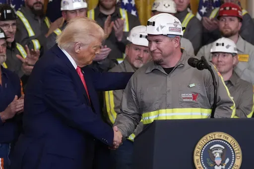 President Donald Trump shakes hands with coal miner Jeff Crowe during an event on energy production in the East Room of the White House, Tuesday, April 8, 2025, in Washington. (AP Photo/Alex Brandon)