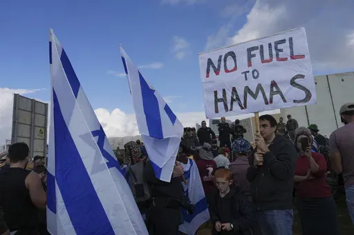 Israeli police prevent activists from blocking trucks carrying humanitarian aid into the Gaza Strip at the Kerem Shalom border crossing, southern Israel, Monday, Jan. 29, 2024. (AP Photo/Tsafrir Abayov, File)