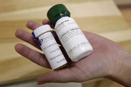 Bottles of abortion pills mifepristone, left, and misoprostol, right, are displayed at a clinic in Des Moines, Iowa, Sept. 22, 2010. (AP Photo/Charlie Neibergall, File)