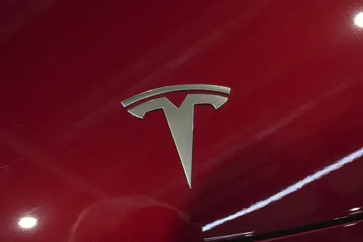 The logo of Tesla car is pictured at the Paris Auto Show, in Paris, Oct. 14, 2024. (AP Photo/Michel Euler, File)
