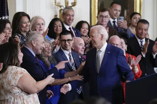 President Joe Biden turns to the others on the dais after speaking during an event marking the 12th anniversary of the Deferred Action for Childhood Arrivals program, in the East Room of the White House in Washington, Tuesday, June 18, 2024. (AP Photo/Susan Walsh)