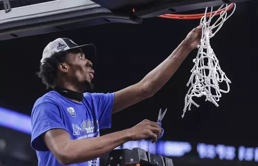 Memphis forward DeAndre Williams cuts down the net after the team's win in the final against Houston in the American Athletic Conference men's basketball tournament March 12, 2023, in Fort Worth, Texas. The NCAA once again has denied a waiver for Williams to play this season at Memphis, keeping the oldest player in Division I last season off coach Penny Hardaway's roster. Memphis confirmed the denial Friday, Nov. 3. (Patrick Lantrip/Daily Memphian via AP, File)
