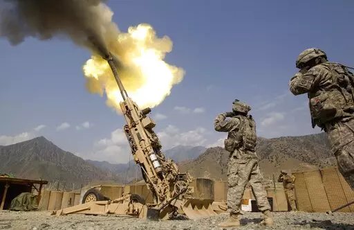 A 155mm round is fired from a 777 Howitzer canon at insurgents during a firing mission by soldiers with 2nd Platoon, Charlie Battery, 3rd Battalion, 321 Field Artillery Regiment out of Fort Bragg, N.C., July 8, 2011, at Forward Operating Base Bostick in Kunar province, Afghanistan. The Biden administration's decision to dramatically ramp up delivery of artillery guns to Ukraine eight weeks into the war signals a deepening American military commitment at a pivotal stage of fighting for the countr