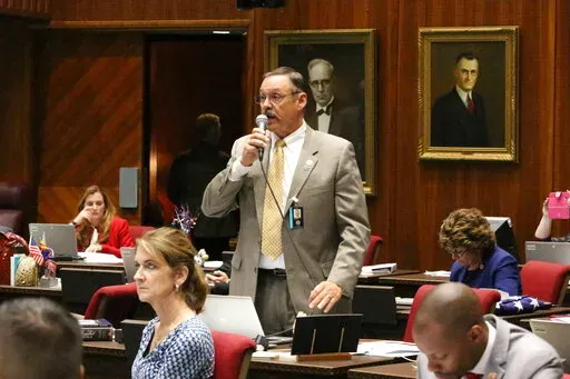 FILE - Republican Rep. Mark Finchem speaks May 2, 2018, at the Capitol in Phoenix. In the year since the Jan. 6 riot, Donald Trump-aligned Republicans have worked to clear the path for next time. In battleground states and beyond, Republicans are systematically taking hold of the once overlooked machinery of elections, weakening or replacing the checks in place to prevent partisan meddling with results. (AP Photo/Bob Christie, File)
