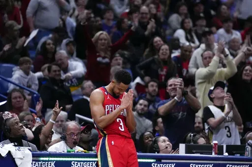 New Orleans Pelicans guard CJ McCollum (3) reacts to the crowd as he was acknowledged for setting a franchise record of eleven 3-pointers in a game, in the second half of an NBA basketball game against the Philadelphia 76ers in New Orleans, Friday, Dec. 30, 2022. McCollum also set his season high in scoring with 42 points, and the Pelicans won 127-116. (AP Photo/Gerald Herbert)