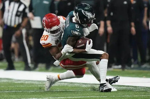 Philadelphia Eagles wide receiver DeVonta Smith (6) is hit by Kansas City Chiefs safety Justin Reid (20) during the second half of the NFL Super Bowl 59 football game, Sunday, Feb. 9, 2025, in New Orleans. (AP Photo/Frank Franklin II)