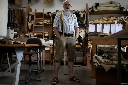 Saddler Klaus Bensmann works in his store in Bad Hindelang, Germany, Wednesday, Sept. 13, 2023. Bensmann produces tailored leather trousers and vests with hand embroidery. The leather comes from the alpine region and is tanned in Germany. For the upcoming Oktoberfest, many visitors like to wear the traditional dress. The 189th Oktoberfest, the world's biggest beer festival, runs from Sept. 16 through Oct. 3, 2023.(AP Photo/Matthias Schrader)
