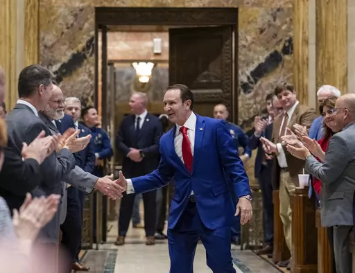 Gov. Jeff Landry shakes hands with representatives while entering the House chamber during the first day of a special session on Monday, Jan. 15, 2024, in Baton Rouge, La. (Michael Johnson/The Advocate via AP, Pool)