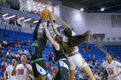 Texas A&M Corpus Christi guards Paige Allen (11) and Annukka Willstedt, center, vie for a rebound against Lamar guard T'Aaliyah Miner, center right, in the first half of the NCAA Southland Conference college basketball championship in Lake Charles, La., Thursday, March 14, 2024. (AP Photo/Matthew Hinton)
