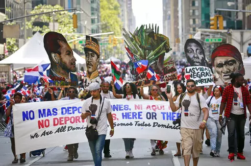 A group calling for the end of deportations marches in the Dominican Day Parade, Sunday, Aug. 13, 2017, in New York. A new report released Monday, May 2, 2022 by Pew Research Center says about 6 million adults in the United States identify as Afro Latino, a distinction with deep roots in colonial Latin America. That’s about 2% of the adult U.S. population and 12% of the adult Latino population in the U.S. Many Hispanic people identify themselves based on their ancestral countries of origin, th