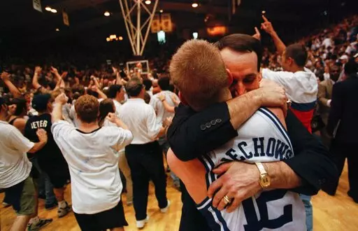 Duke coach Mike Krzyzewski, right, hugs senior Steve Wojciechowski after the guard helped the team in a comeback against North Carolina for a win Feb. 28, 1998, in Durham, N.C. The 1998 matchup ranks as one of the most memorable matchups between rivals Duke and North Carolina in the Krzyzewski era entering Saturday’s first-ever NCAA Tournament game in the Final Four. (Christopher A. Record/The Charlotte Observer via AP, File)
