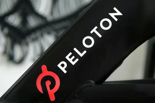 A Peloton logo is seen on the company's stationary bicycle on Nov. 19, 2019, in San Francisco. In a statement  on Wednesday, Aug. 24, 2022, Peloton announced that their high-end exercise bikes and other gear will now be available for purchase on Amazon in the U.S., a partnership aimed at boosting the fitness company's sales that have languished since the easing of pandemic lockdowns. (AP Photo/Jeff Chiu, File)