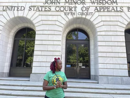 Teliah Perkins stands in front of the federal appeals court building in New Orleans on May 3, 2023, following a hearing on her lawsuit against two St. Tammany Parish, La., sheriff's deputies stemming from her arrest in May 2020. The deputies asked the appeals court to throw out her excessive force lawsuit, which was filed by lawyers working with the American Civil Liberties Union of Louisiana. (AP Photo/Kevin McGill)