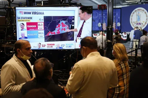 Supporters of Democrat Terry McAuliffe watch vote reports at an election party in McLean, Va., Tuesday, Nov. 2, 2021.(AP Photo/Steve Helber, File)