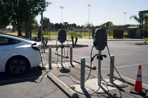 Electric vehicle chargers are seen in the parking lot of South El Monte High School in South El Monte, Calif., Friday, Aug. 26, 2022. Discounted prices, car-share programs, and a robust network of public charging stations are among the ways California will try to make electric vehicles affordable and convenient for people of all income levels as it phases out the sale of new gas cars by 2035. Advocates for the policy say the switch from gas- to battery-powered cars is a necessary step to reducin