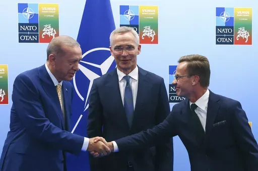 Turkey's President Recep Tayyip Erdogan, left, shakes hands with Sweden's Prime Minister Ulf Kristersson, right, as NATO Secretary General Jens Stoltenberg looks on prior to a meeting ahead of a NATO summit in Vilnius, Lithuania, Monday, July 10, 2023. The Turkish parliament’s foreign affairs committee was poised on Tuesday, Dec. 26, 2023, to resume deliberations on Sweden’s bid to join NATO, days after President Recep Tayyip Erdogan linked the Nordic country’s admission on U.S. approval o