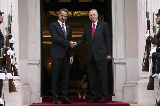 Greece's Prime Minister Kyriakos Mitsotakis, left, welcomes the Turkey's President Recep Tayyip Erdogan before their meeting at Maximos Mansion in Athens, Greece, Thursday, Dec. 7, 2023. Old foes Turkey and Greece will test a five-month-old friendship initiative on Monday, May 13, 2024 when Greek Prime Minister Kyriakos Mitsotakis visits Ankara. (AP Photo/Thanassis Stavrakis, File)