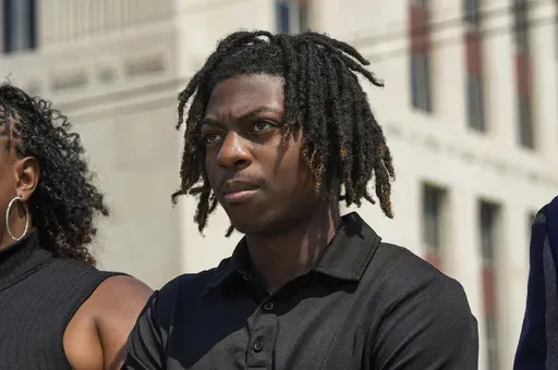 Darryl George stands next to his mother, Darresha George, in front of Galveston County Court House, May 23, 2024, in Galveston, Texas. A federal judge on Friday, Oct. 4, 2024 denied a request by Darryl George, a Black high school student in Texas for a court order that the student’s lawyers say would have allowed him to return to his high school without fear of having his previous punishment over his hairstyle resume.(Raquel Natalicchio/Houston Chronicle via AP, File)