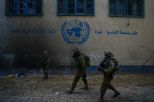 Israeli soldiers take position as they enter the UNRWA headquarter where the military discovered tunnels underneath of the U.N. agency that the military says Hamas militants used to attack its forces during a ground operation in Gaza, Thursday, Feb. 8, 2024. (AP Photo/Ariel Schalit, File)