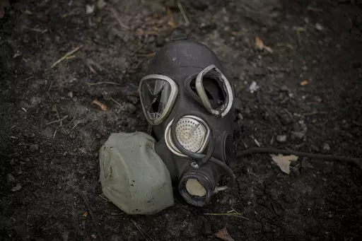 A damaged gas mask lies on the pavement at a Russian position which was overran by Ukrainian forces, outside Kyiv, Ukraine, March 31, 2022. Russia’s assault on Ukraine and its veiled threats of using nuclear arms have policymakers questioning how the West should respond to a Russian battlefield explosion of a nuclear bomb. The default U.S. policy answer, say some architects of the post-Cold War nuclear order, is with discipline and restraint. (AP Photo/Vadim Ghirda, File)