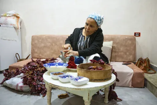 Chahida Boufaied, owner of Dar Chahida Lel Oula, prepares the Harissa in her house in Nabeul, Tunisia, Jan. 7, 2025. (AP Photo/Ons Abid)