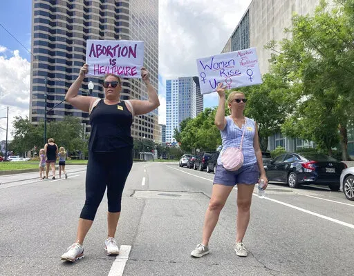 Protesters wave signs and demonstrate in support of abortion access in front of a New Orleans courthouse on July 8, 2022. Louisiana authorities have once again been blocked from enforcing the state’s near total ban on abortion. A state judge in Baton Rouge released an order Tuesday, July 12, 2022, blocking enforcement while lawyers for a north Louisiana clinic and other supporters of abortion rights pursue a lawsuit. (AP Photo/Rebecca Santana, File)
