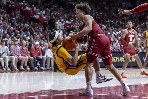 LSU guard Curtis Givens III, left, and Alabama guard Mark Sears battle for a loose ball during the first half of an NCAA college basketball game, Saturday, Jan. 25, 2025, in Tuscaloosa, Ala. (AP Photo/Vasha Hunt)
