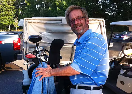 In this photo provided by Bob Van Wert, Tom Randele, whose real name according to authorities is Ted Conrad, tends to golf clubs, in September 2012, in Ayer, Mass. Conrad, a former Ohio bank teller-turned-thief, lived for decades under a different name in suburban Boston. Conrad died in May 2021. (Bob Van Wert via AP)