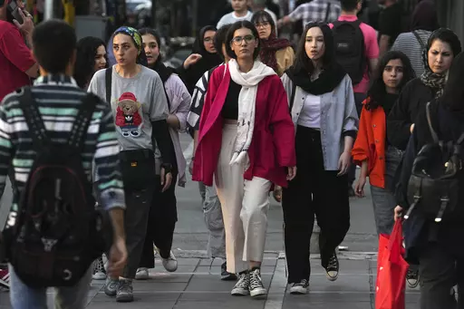 Iranian women, some without wearing their mandatory Islamic headscarves, walk in downtown Tehran, Iran, Saturday, Sept. 9, 2023. Iran's parliament on Wednesday, Sept. 20, 2023, approved a bill to impose heavier penalties on women who refuse to wear the mandatory Islamic headscarf in public and those who support them. The move came just days after the anniversary of the death of Mahsa Amini, a 22-year-old woman who had been detained by the morality police for violating the country's dress code. (