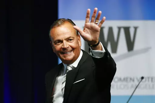 Businessman Rick Caruso waves at the start of a mayoral debate at the Student Union Theater on the California State University, Los Angeles campus on Sunday, May 1, 2022. Los Angeles is a heavily Democratic city, but voters this year could take a right turn. Caruso, a billionaire former longtime Republican who sits on the Ronald Reagan Presidential Foundation board, is a leading candidate for mayor and is promising to expand, not defund, police. (Ringo Chiu/Los Angeles Times via AP, File)
