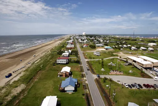 Louisiana State Highway 1 is seen from a Blackhawk helicopter above Grand Isle, La., on July 27, 2010. According to a federal lawsuit filed Tuesday, Jan. 24, 2023, the Louisiana resort town of Grand Isle is trying to suppress free speech with an ordinance aimed at stopping a contractor from flying flags emblazoned with vulgar insults aimed at President Joe Biden and his supporters. (AP Photo/Patrick Semansky, File)