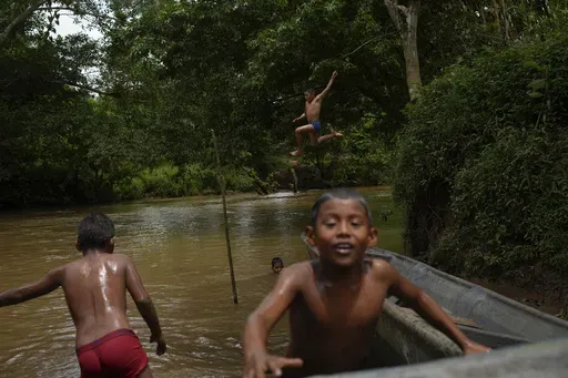 Children in El Jobo village play in the Indio River, which could have its flow reduced under a proposed plan to secure the Panama Canal’s uninterrupted operation in Panama, Saturday, Aug. 31, 2024. (AP Photo/Matias Delacroix)