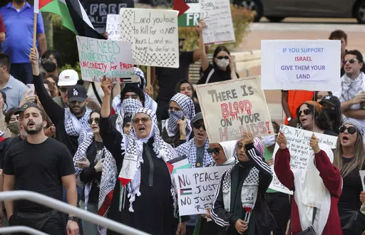 Pro-Palestinian supporters hold up signs during a demonstration at Orlando City Hall, Friday, Oct. 20, 2023, in Orlando, Fla. State lawmakers across the country are expected consider legislation related to the Israel-Hamas war in 2024. (Joe Burbank/Orlando Sentinel via AP, File)