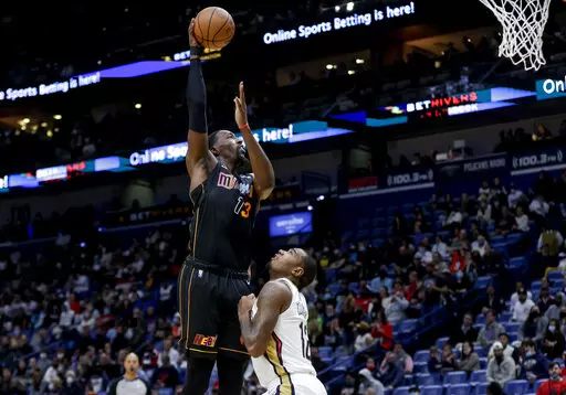 Miami Heat center Bam Adebayo (13) shoots over New Orleans Pelicans forward Gary Clark (12) in the second quarter of an NBA basketball game in New Orleans, Thursday, Feb. 10, 2022. (AP Photo/Derick Hingle)