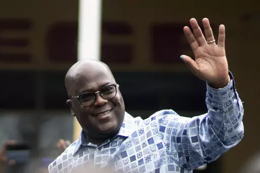 Congo's President Felix Tshisekedi waves to his supporters after casting his ballot inside a polling station during the presidential elections in Kinshasa, Democratic Republic of Congo, Wednesday, Dec. 20, 2023. Congo’s President Felix Tshisekedi wins reelection with over 70% of vote, election commission says. (AP Photo/Mosa'ab Elshamy, File)