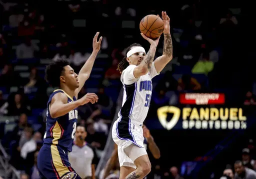 Orlando Magic guard Cole Anthony (50) shoots past New Orleans Pelicans guard Trey Murphy III (25) during the second half of an NBA basketball game in New Orleans, Wednesday, March 9, 2022. (AP Photo/Derick Hingle)