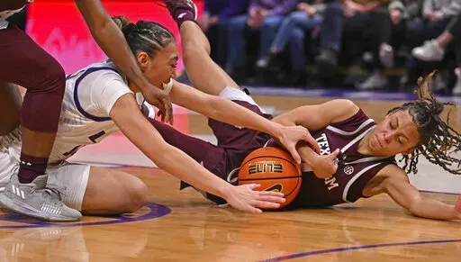 LSU guard Last-Tear Poa, left, and Texas A&M guard Mya Petticord, right, vie for control of the ball during an NCAA college basketball game Thursday, Jan. 5, 2023, in Baton Rouge, La. (Hilary Scheinuk/The Advocate via AP)