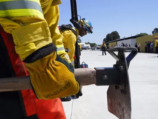 Cadets, who were formerly-incarcerated firefighters, train at the Ventura Training Center (VTC) during an open house media demonstration Thursday, July 14, 2022, in Camarillo, Calif. California has a first-in-the nation law and a $30 million training program both aimed at trying to help former inmate firefighters turn pro after they are released from prison. The 18-month program is run by Cal Fire, the California Conservation Corps, the state corrections department and the nonprofit Anti-Recidiv