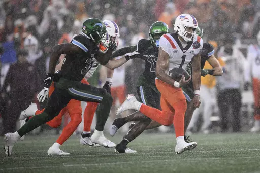 Virginia Tech quarterback Kyron Drones (1) carries the ball during the second half of the Military Bowl NCAA college football game against Tulane, Wednesday, Dec. 27, 2023, in Annapolis, Md. Virginia Tech won 41-20. (AP Photo/Nick Wass)