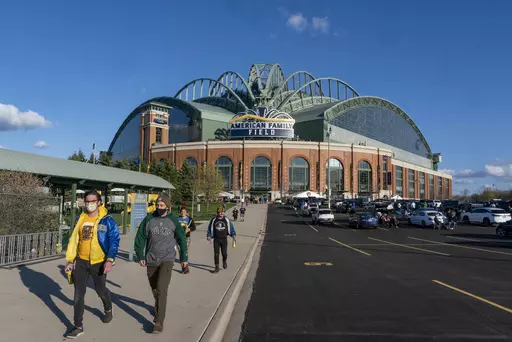 Fans are pictured outside American Family Field before a baseball game between the Milwaukee Brewers and the Chicago Cubs, April 12, 2021, in Milwaukee. Proposals for new and improved sports stadiums are proliferating across the U.S. — and could come with a hefty price tag for taxpayers. (AP Photo/Morry Gash, File)