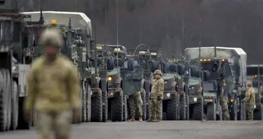 Soldiers of the 2nd Cavalry Regiment line up vehicles at the military airfield in Vilseck, Germany, Wednesday, Feb. 9, 2022 as they prepare for the regiment's movement to Romania loading of Stryker combat vehicles for their deployment to support NATO allies and demonstrate U.S. commitment to NATO Article V. The soldiers will deploy to Romania in the coming days from their post in Vilseck and will augment the more than 900 U.S. service members already in Romania. This Stryker Squadron represents 