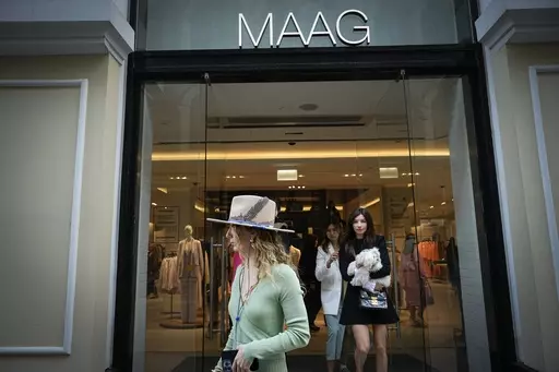 A woman exits a newly opened Maag store, a former Zara flagship store, in Moscow, Russia, Thursday, April 27, 2023. When Russia invaded Ukraine, companies were quick to respond, some announcing they would get out of Russia immediately, others vowed to curtail sales and new investment. More than a year later, it’s clear: Leaving Russia isn't as easy as the first announcements might have made it seem. (AP Photo/Alexander Zemlianichenko, File)